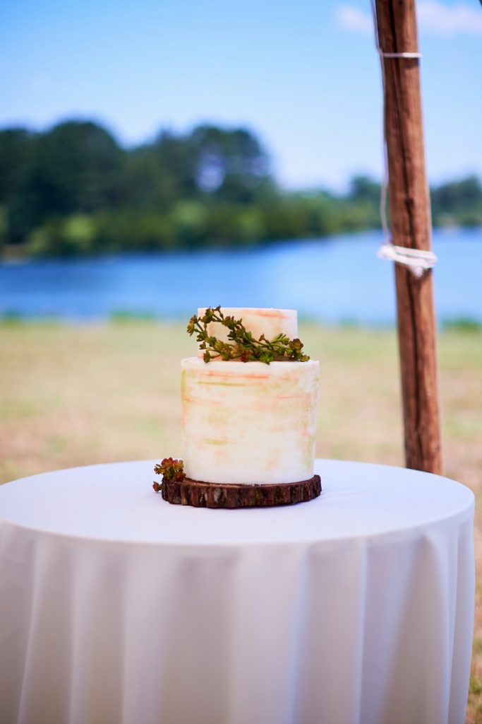 Small two tiered wedding cake with greenery