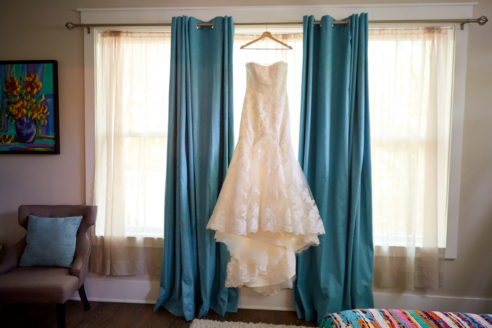 Lace wedding dress hanging in bedroom window of Isle of Palms, SC home