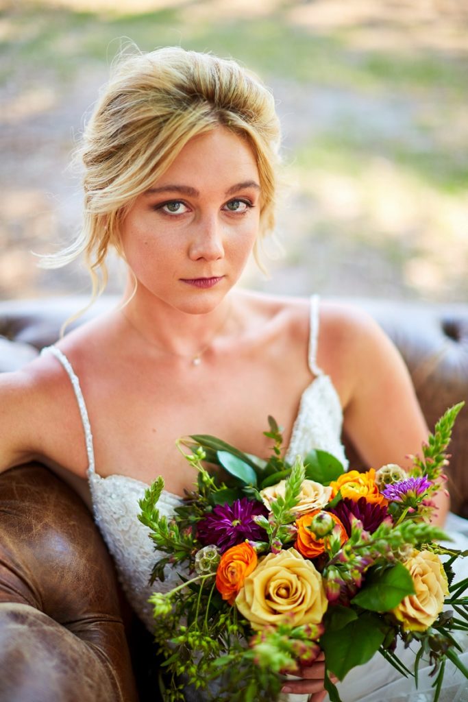 Portrait of bride holding colorful bouquet at Charleston Woodlands
