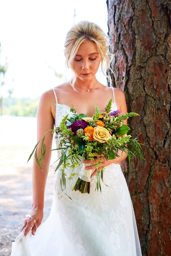 Bride looking down at colorful bouquet