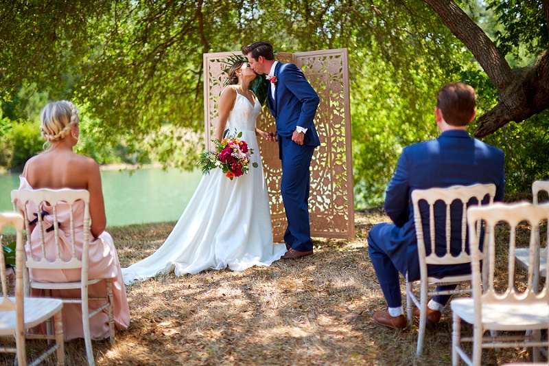 Bride and groom kiss at Charleston Woodlands wedding ceremony