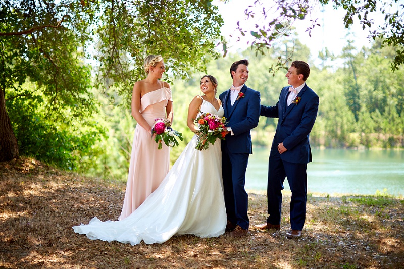 Bride, groom, and wedding party share laughs at Charleston Woodlands