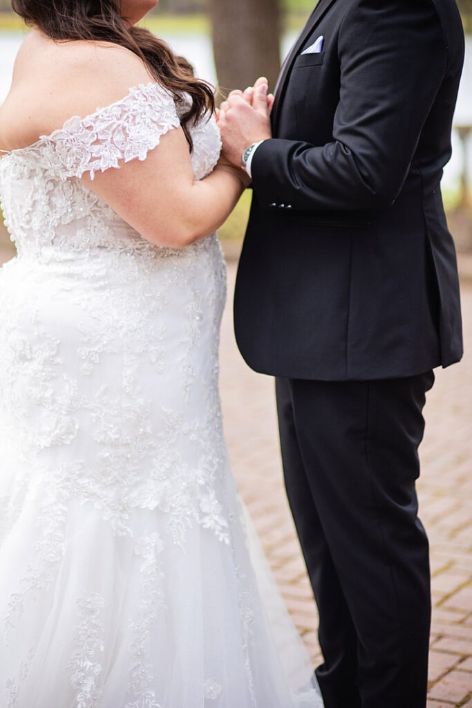 Detail of bride and groom holding hands and praying in their wedding attire, before their wedding  - photographed by Charleston wedding photographer Luxe By Lindsay Photography