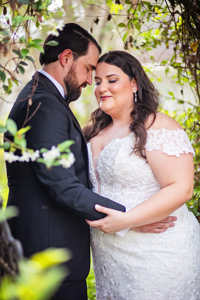 Close up portrait of bride and groom holding each other in a garden setting at Eden at Gracefield wedding - photographed by Charleston wedding photographer Luxe By Lindsay Photography