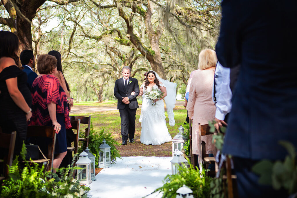 Bride walking down the aisle at her wedding ceremony with her father at Eden at Gracefield - photographed by Charleston wedding photographer Luxe By Lindsay Photography