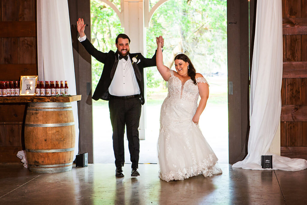 Bride and groom entering into their barn wedding reception at Eden at Gracefield - photographed by Charleston wedding photographer Luxe By Lindsay Photography