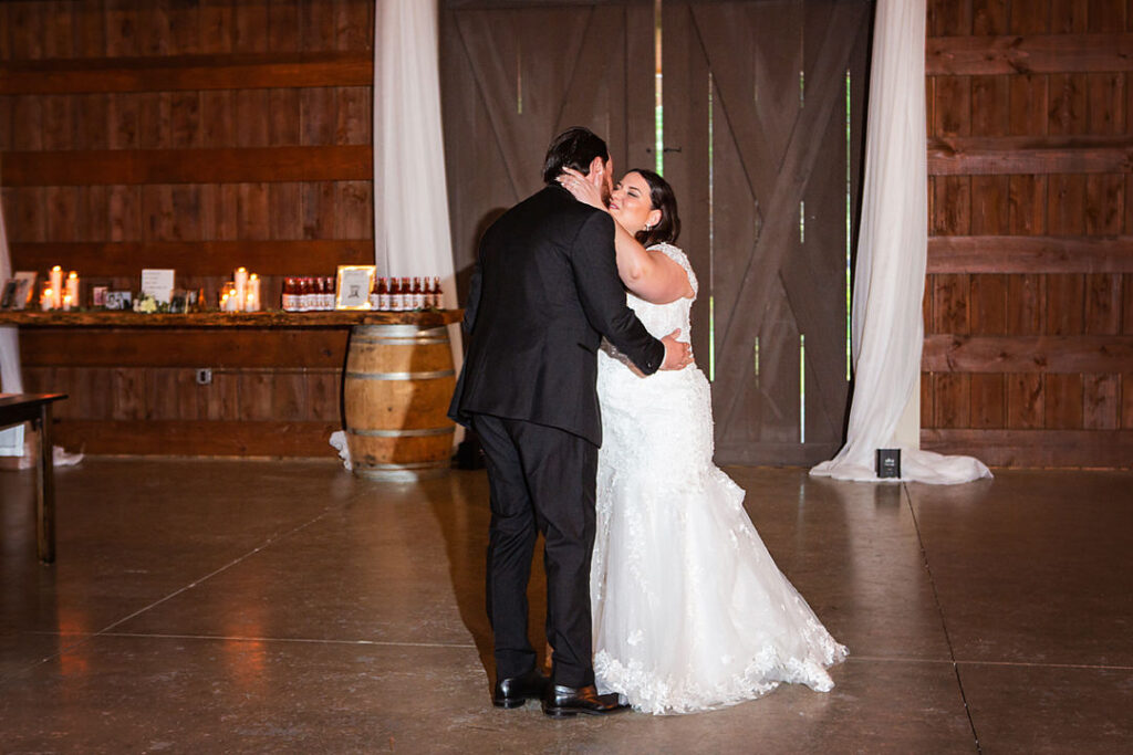 Bride and groom have their first dance as a married couple inside the barn reception hall at Eden at Gracefield - photographed by Charleston wedding photographer Luxe By Lindsay Photography