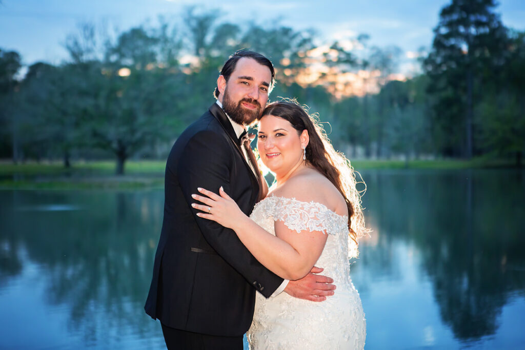 Bride and groom smiling portrait at dusk in front of the lake at Eden at Gracefield - photographed by Charleston wedding photographer Luxe By Lindsay Photography