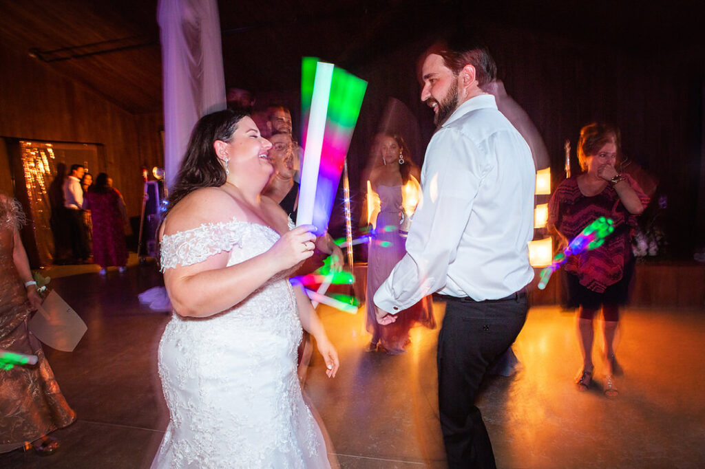 Bride and groom dance with guests and LED wands at Eden at Gracefield wedding reception - photographed by Charleston wedding photographer Luxe By Lindsay Photography