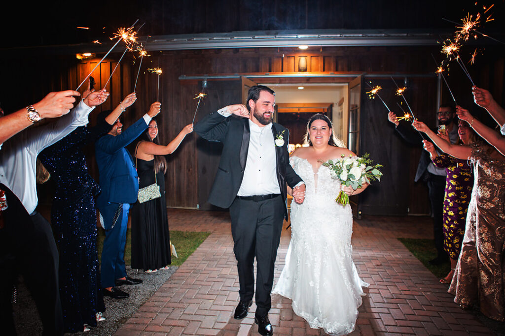 Bride and groom have a sparkler send off outside the barn at Eden at Gracefield - photographed by Charleston wedding photographer Luxe By Lindsay Photography